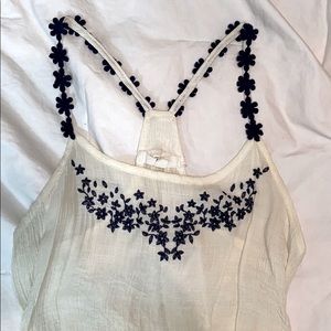 Cream colored tank with navy blue detail